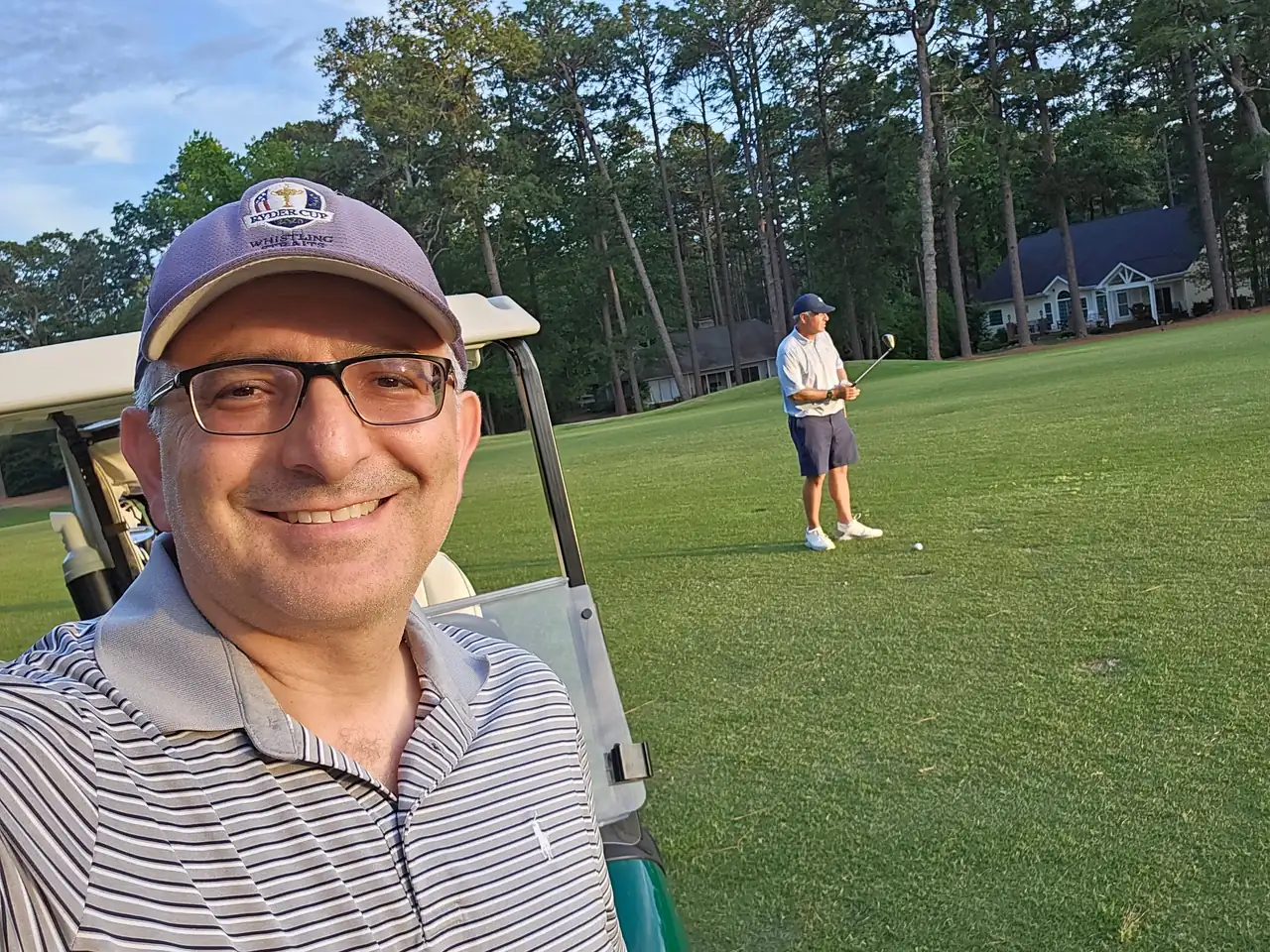 Jon Perry by the cart while his playing partner swings on Pinehurst No. 1