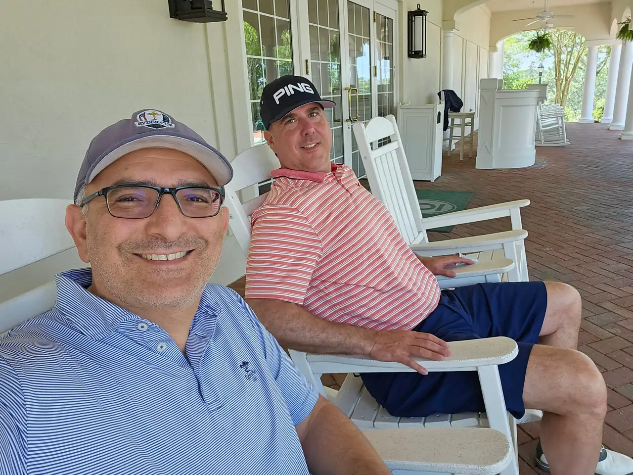 Two of the group in rocking chairs on the clubhouse porch after the round on Pinehurst No. 8