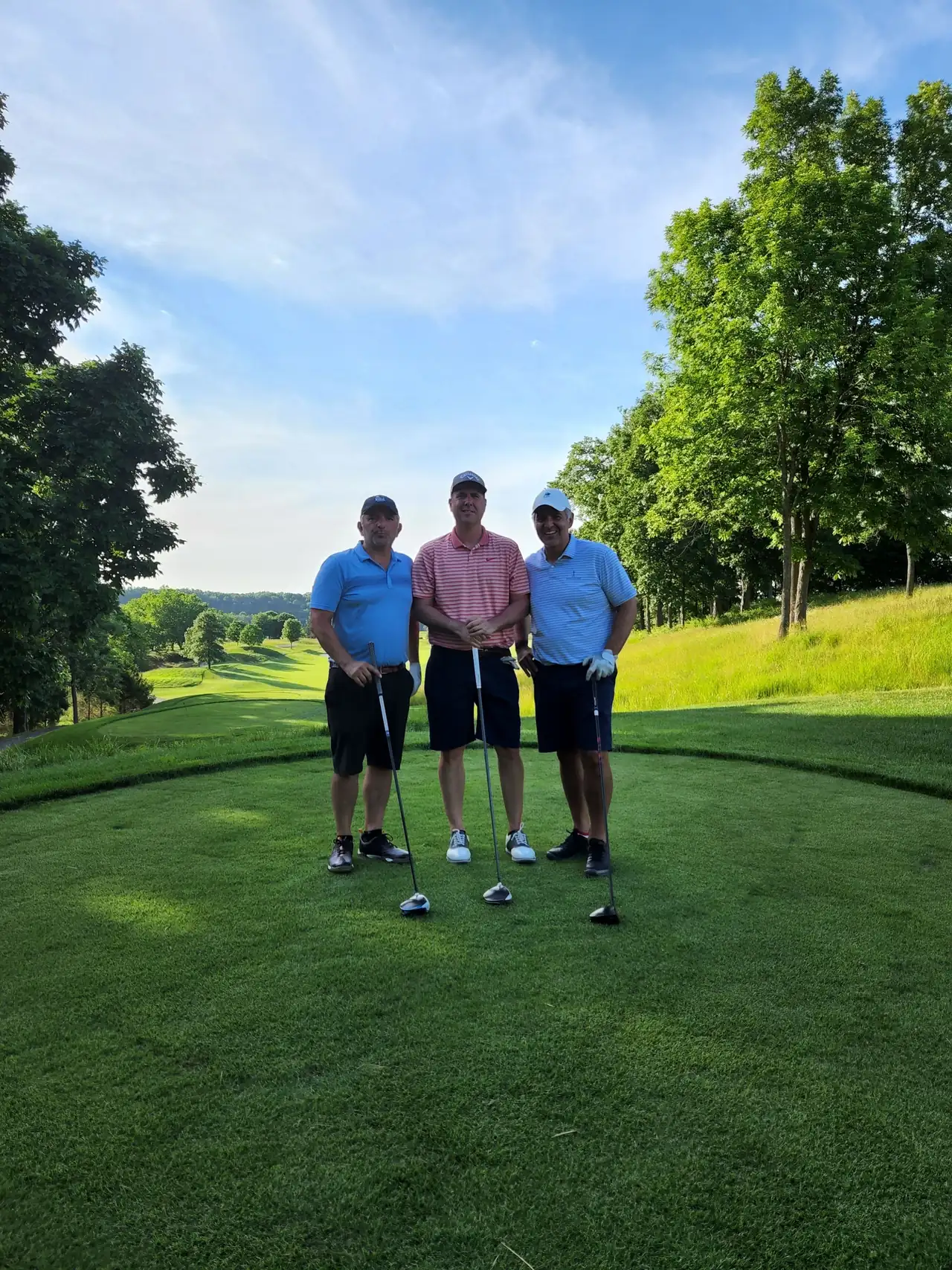 The Perry Bros and Brandon on a Valhalla Golf Club tee box on a clear June evening